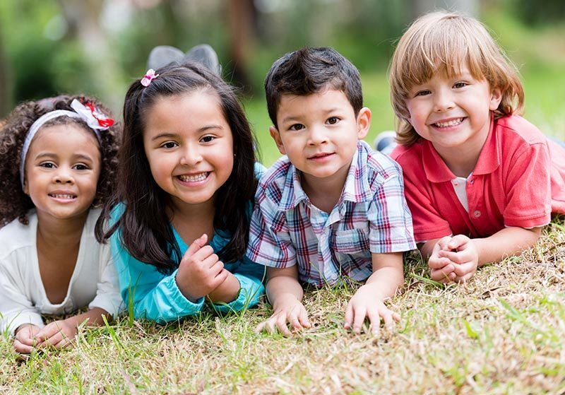 Smiling children in the grass