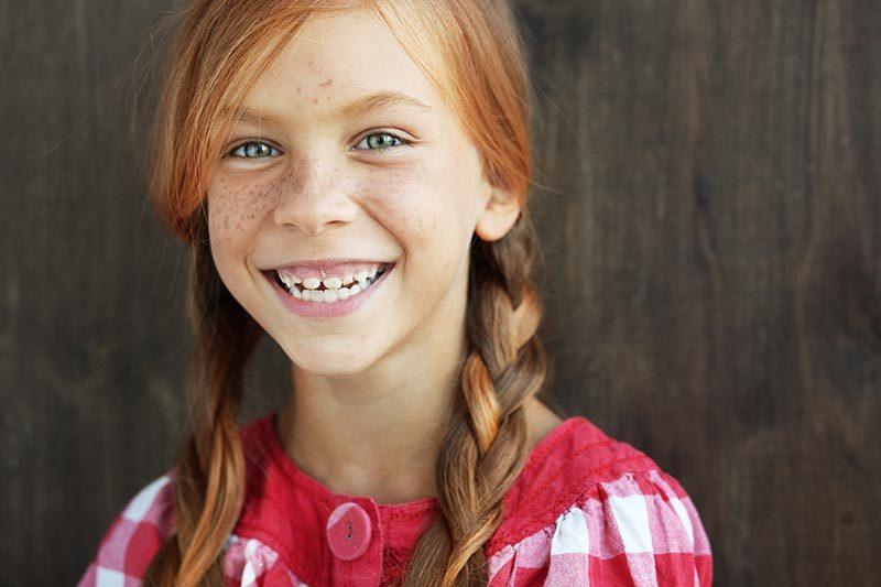 Smiling redhead with pigtails
